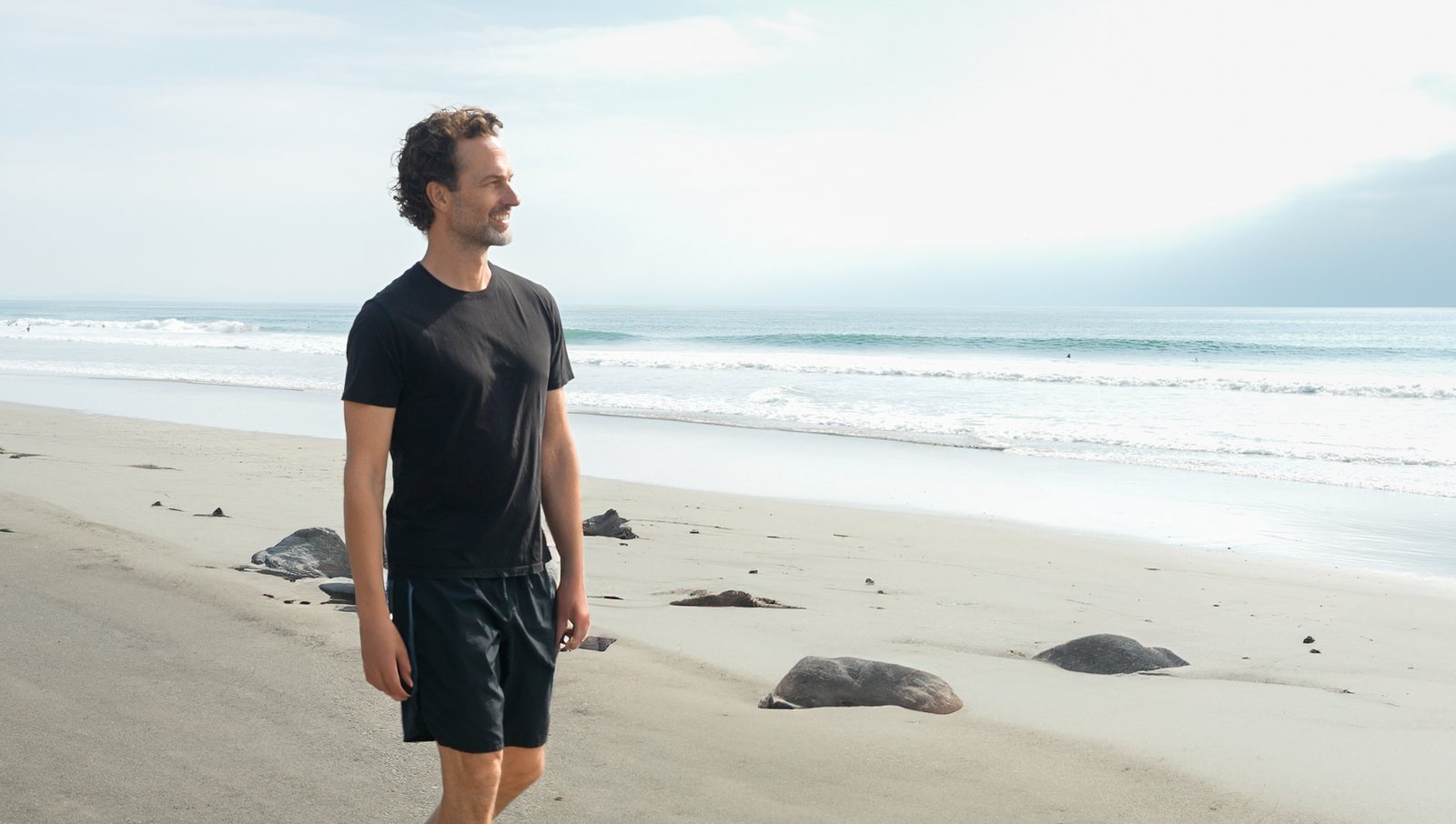 Man walking along a misty beach, health app brand film
