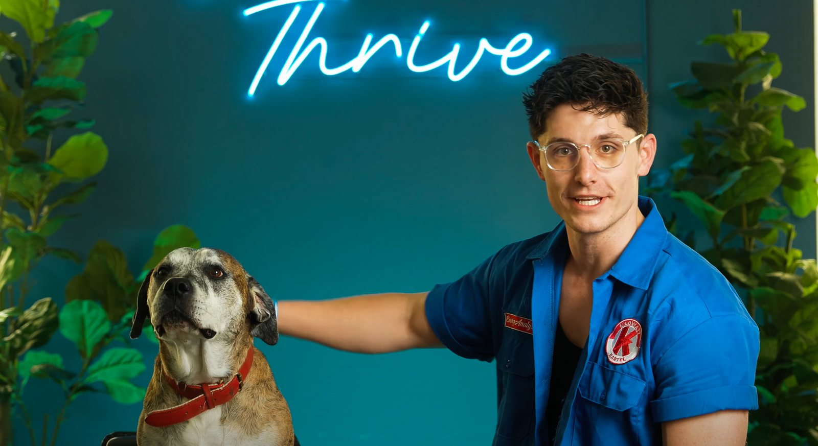 Pacific United Power host with his dog under a Thrive neon sign, course launch video
