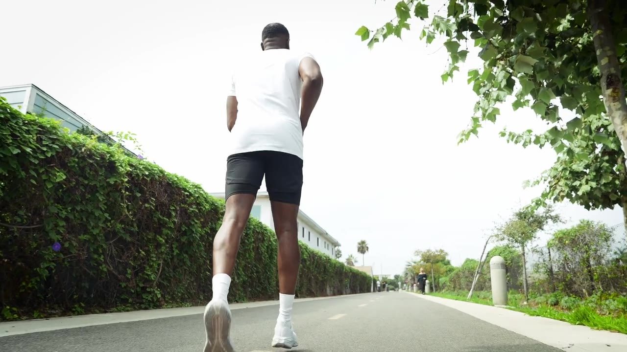 Runner on a hedge-lined street for Rootlabs